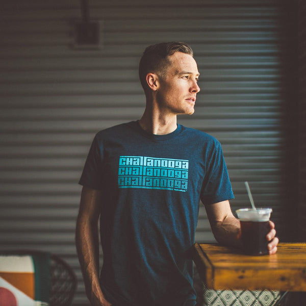 Model drinking coffee at the Camp House while wearing the NativeMade Chattanooga Fade Tee