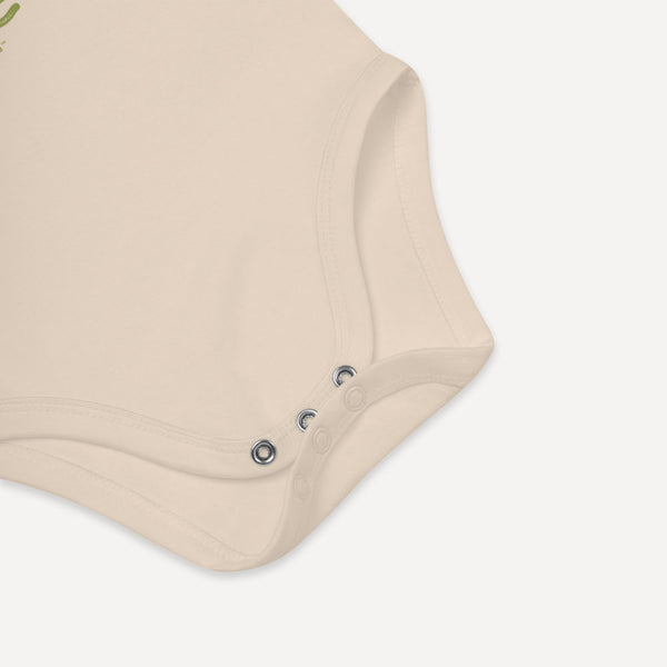 detail shot of the Tenn Badge baby onesie