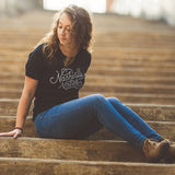 Model sitting wearing the Nashville Native T-shirt in Heather black