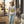 Load image into Gallery viewer, Model walking in downtown Chattanooga wearing our Bella Canvas heather dust crewneck featuring our NativeMade Raccoon Mountain Chattanooga design.
